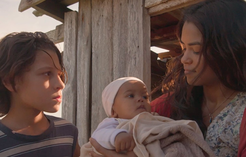 Lurdes ao achar uma recém nascida no caminho do Rio de Janeiro em Amor de Mãe (Foto: Reprodução)