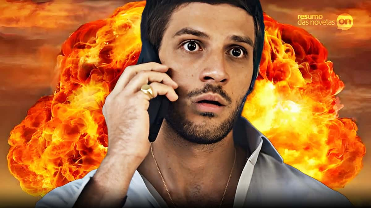 Ari com o celular no ouvido e, no fundo, uma explosão na novela Travessia