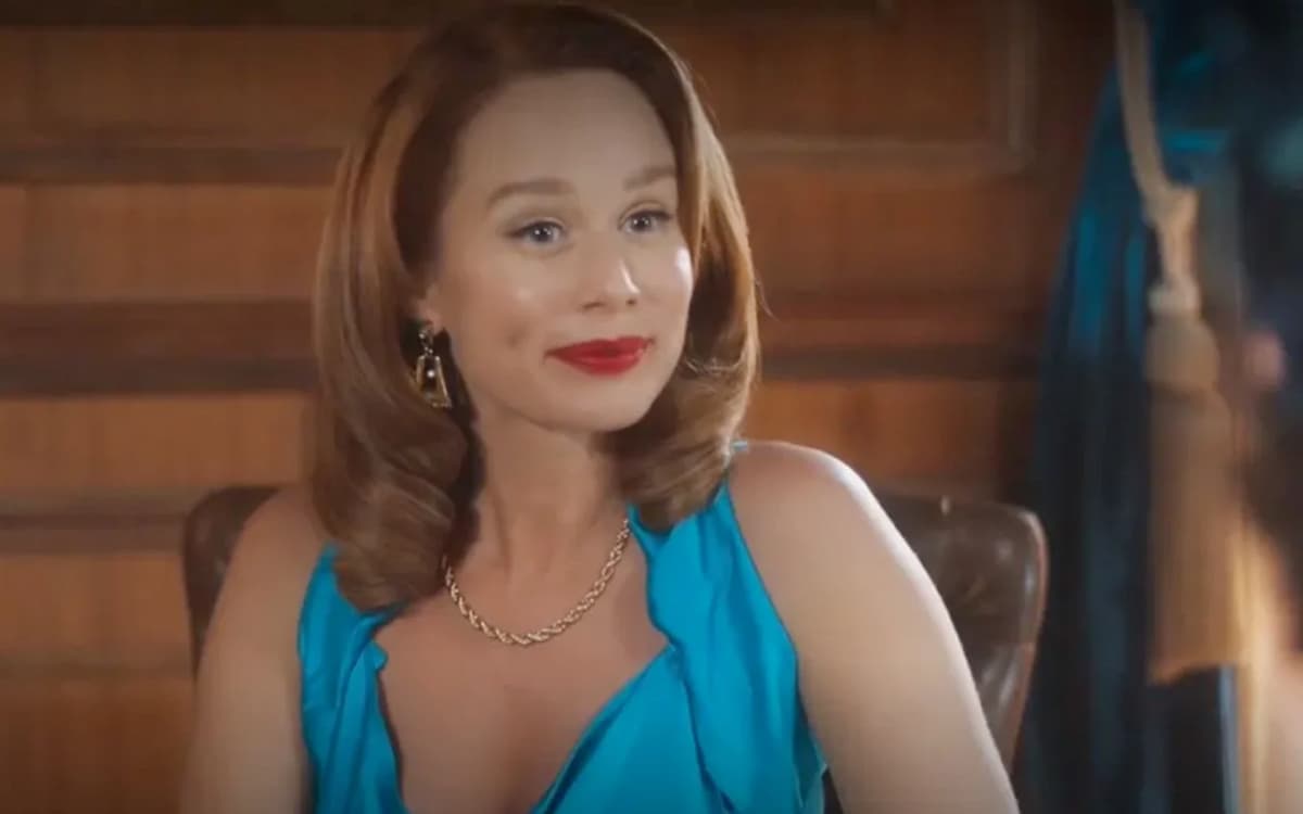 Gilda, personagem de Mariana Ximenes, usando um batom vermelho e um vestido azul bebê, em cena da novela Amor Perfeito.