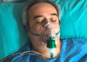 Enver com uma máscara de oxigênio no hospital, em Força de Mulher.