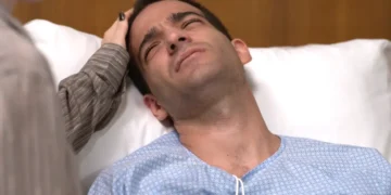 Afonso deitado em uma cama de hospital, com Solange acariciando sua cabeça em cena de Vale Tudo.