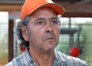 Joaquim, personagem de Marcos Palmeira, sério, usando um boné laranja, em cena da novela Três Graças.