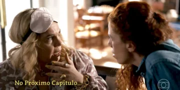 Cena da novela Quem Ama Cuida mostra Pilar, usando uma máscara de dormir na cabeça, com expressão assustada e a mão próxima ao rosto, enquanto Zeni, de cabelos ruivos e camisa jeans, se aproxima para conversar com ela. A imagem traz a frase “No Próximo Capítulo...” e o logotipo da Globo.